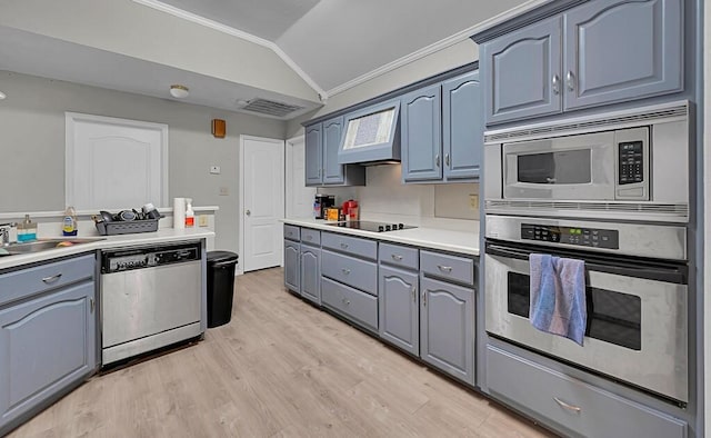 2618 S 2nd St, Waco, TX 76706 - kitchen with stainless steel appliances, vaulted ceiling, a sink, light wood-style floors, and crown molding