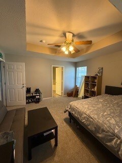 2618 S 2nd St, Waco, TX 76706 - carpeted bedroom featuring a ceiling fan and a raised ceiling