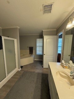 2618 S 2nd St, Waco, TX 76706 - bathroom featuring crown molding, vanity, visible vents, and a stall shower