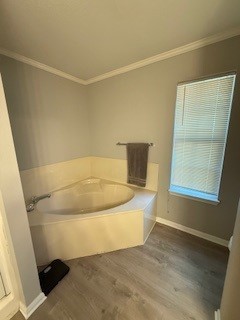 2618 S 2nd St, Waco, TX 76706 - bathroom featuring wood finished floors, a garden tub, baseboards, and ornamental molding