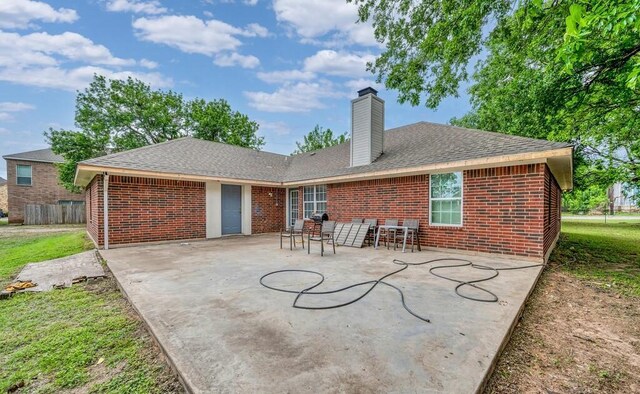 2618 S 2nd St, Waco, TX 76706 - rear view of house with brick siding, fence, a patio, and a shingled roof