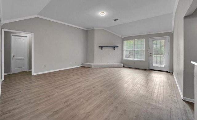 2618 S 2nd St, Waco, TX 76706 - unfurnished living room with vaulted ceiling, crown molding, wood finished floors, and visible vents