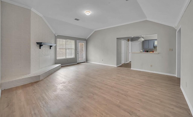 2618 S 2nd St, Waco, TX 76706 - unfurnished living room with vaulted ceiling, light wood finished floors, baseboards, ornamental molding, and visible vents