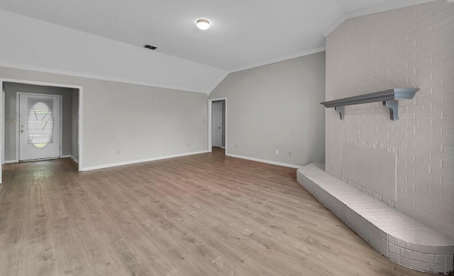 2618 S 2nd St, Waco, TX 76706 - unfurnished living room with vaulted ceiling, wood finished floors, visible vents, crown molding, and baseboards