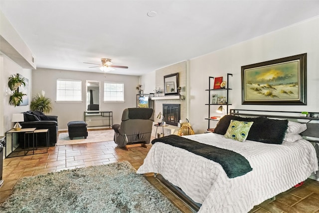 bedroom featuring baseboards and a glass covered fireplace