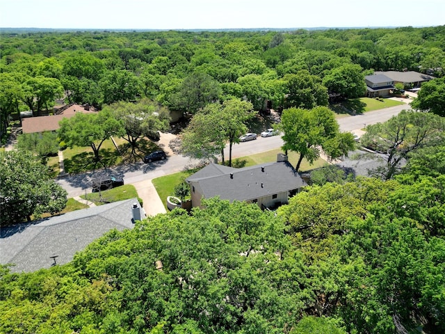birds eye view of property featuring a view of trees