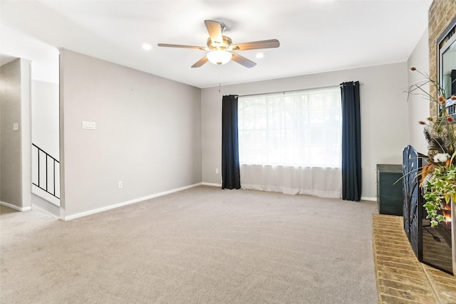 unfurnished room featuring baseboards, carpet floors, and ceiling fan