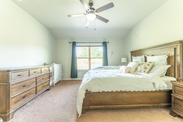 bedroom with vaulted ceiling, a ceiling fan, and light carpet