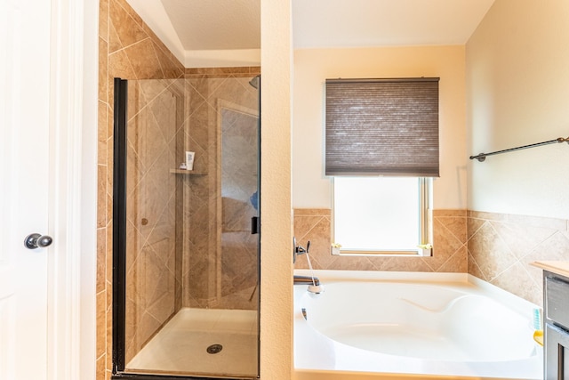 bathroom with a garden tub and a stall shower