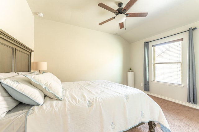 bedroom with lofted ceiling, light carpet, a ceiling fan, and baseboards