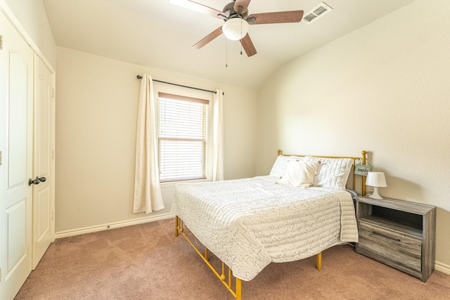 bedroom featuring a ceiling fan, carpet floors, lofted ceiling, and visible vents