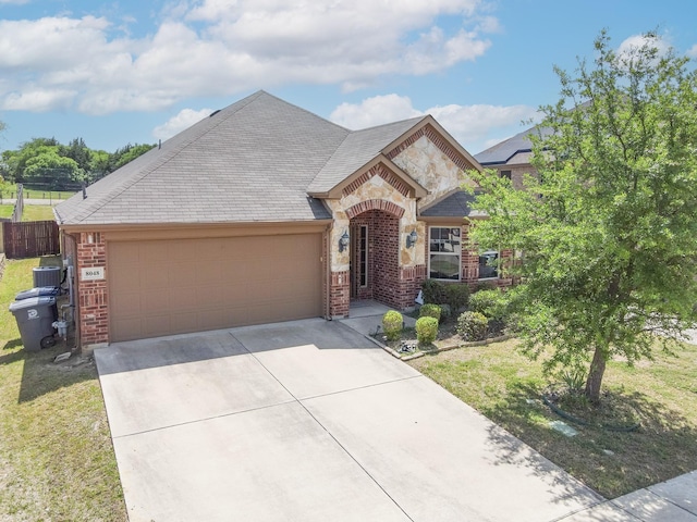 french provincial home featuring concrete driveway, an attached garage, brick siding, and stone siding