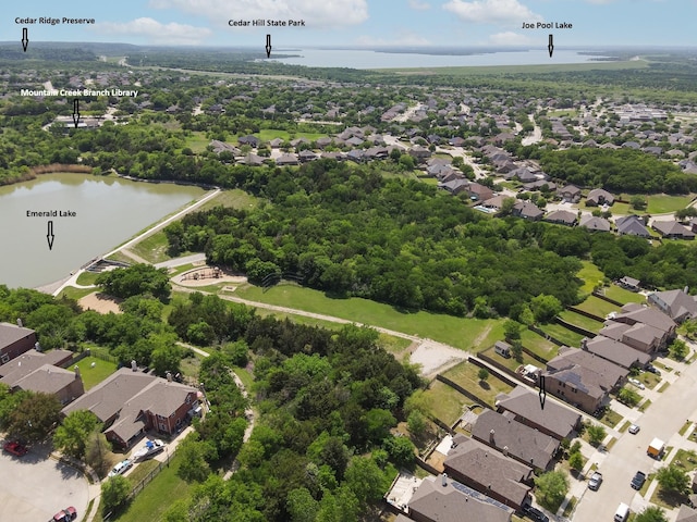drone / aerial view with a residential view and a water view