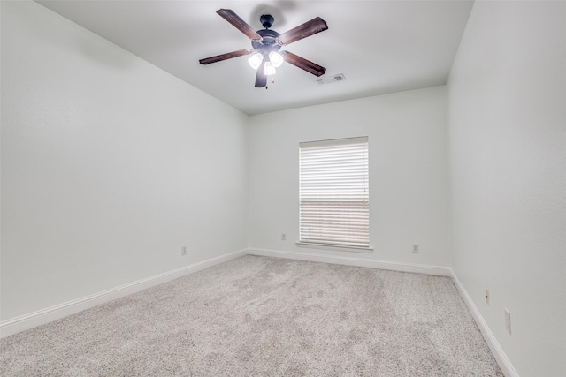 spare room featuring ceiling fan, baseboards, carpet flooring, and visible vents