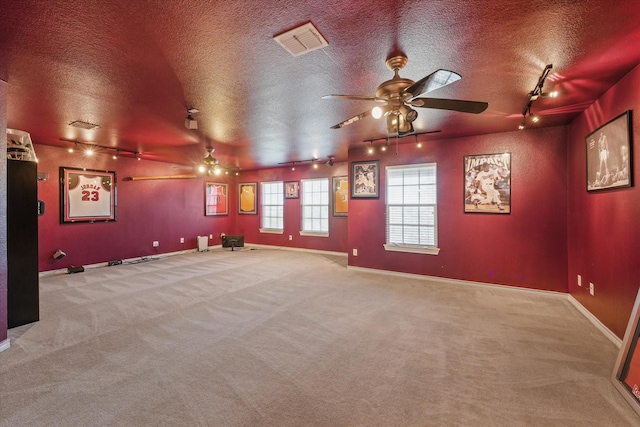 1603 Willow Ln, Cedar Hill, TX 75104 - cinema room featuring rail lighting, a ceiling fan, visible vents, baseboards, and a textured ceiling