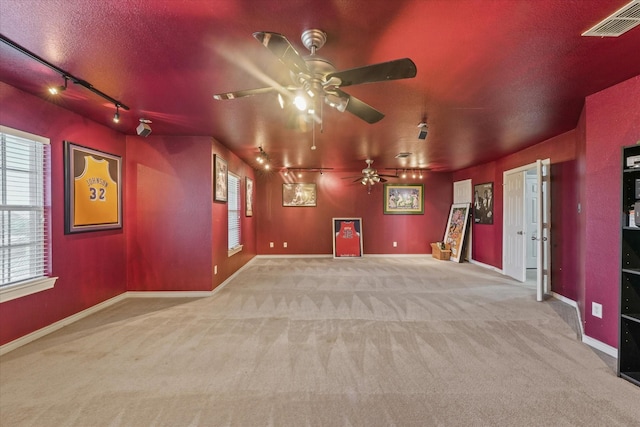 1603 Willow Ln, Cedar Hill, TX 75104 - cinema room featuring track lighting, a ceiling fan, carpet floors, and plenty of natural light
