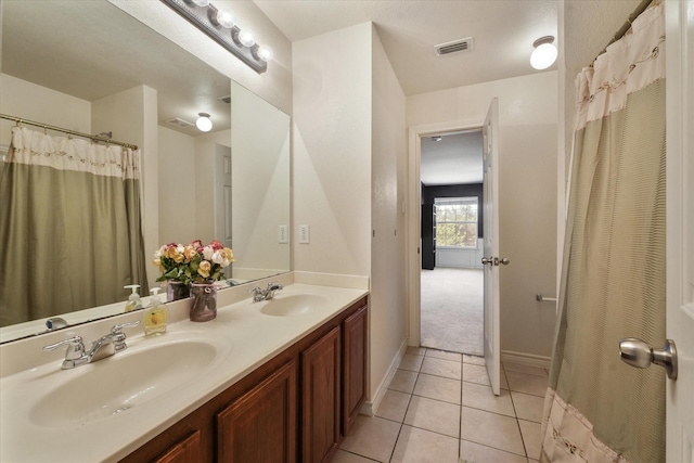 1603 Willow Ln, Cedar Hill, TX 75104 - full bath featuring double vanity, visible vents, tile patterned flooring, and a sink