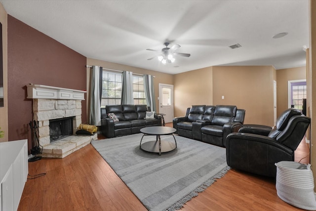 1603 Willow Ln, Cedar Hill, TX 75104 - living area with visible vents, a ceiling fan, a stone fireplace, and plenty of natural light