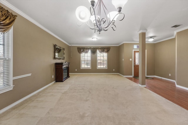 1603 Willow Ln, Cedar Hill, TX 75104 - unfurnished living room featuring a chandelier, decorative columns, crown molding, visible vents, and light carpet