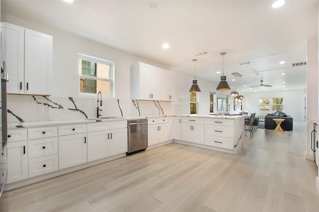 kitchen featuring recessed lighting, dishwasher, visible vents, a sink, and a peninsula