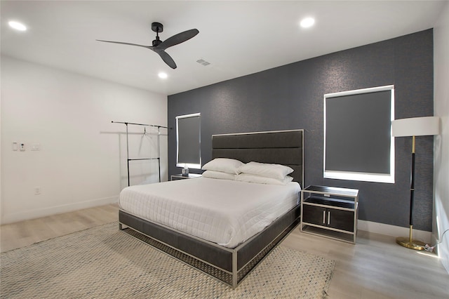 bedroom with a ceiling fan, light wood-style floors, visible vents, and recessed lighting