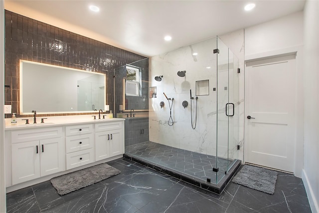 full bath with marble finish floor, a sink, a marble finish shower, and recessed lighting