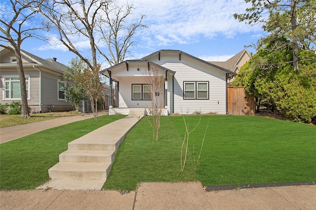 bungalow-style home featuring central AC, a front yard, and covered porch
