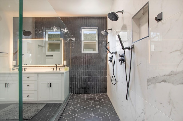 full bath with tile walls, walk in shower, vanity, and tile patterned flooring