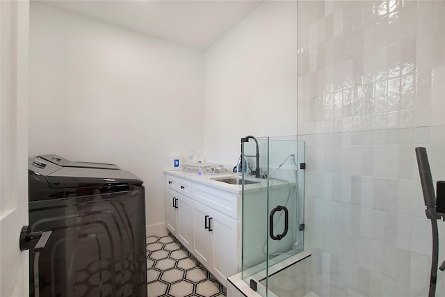 full bathroom with washing machine and clothes dryer, vanity, and a shower stall
