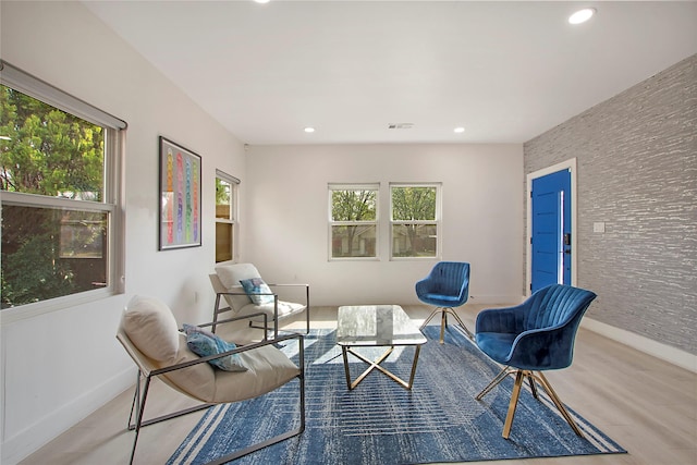 sitting room with recessed lighting, wood finished floors, a wealth of natural light, and baseboards