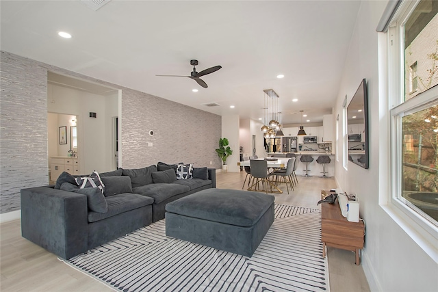 living area featuring a ceiling fan, light wood-style floors, visible vents, and recessed lighting