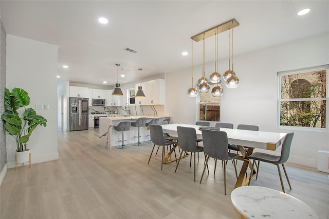 dining area with recessed lighting, light wood-style floors, visible vents, and baseboards