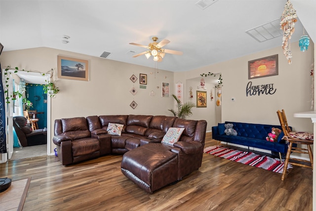living area with visible vents, wood finished floors, and ceiling fan