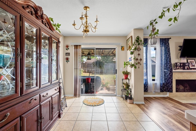 foyer featuring a premium fireplace, a wealth of natural light, and baseboards