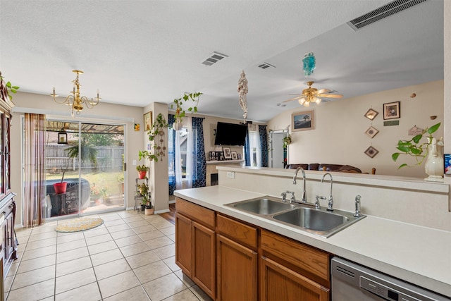 kitchen with a sink, light tile patterned flooring, dishwasher, light countertops, and visible vents