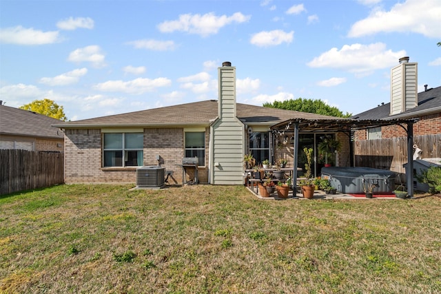 rear view of house with a pergola, brick siding, a hot tub, and a fenced backyard