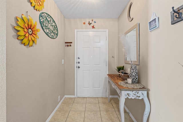 entryway featuring baseboards and light tile patterned floors