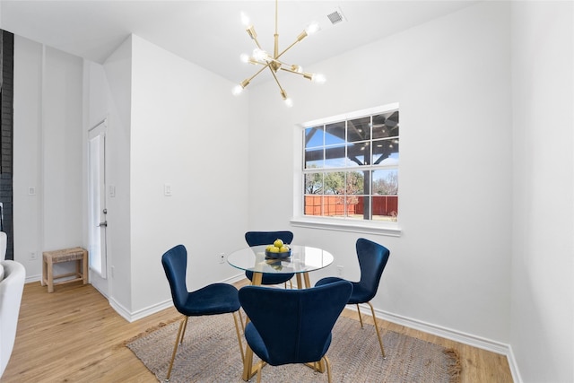 7022 Cottonwood Cir, Sachse, TX 75048 - dining area with a chandelier, light wood-type flooring, and baseboards
