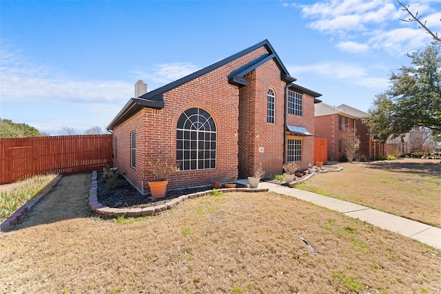 7022 Cottonwood Cir, Sachse, TX 75048 - view of property exterior with brick siding, a lawn, a chimney, and fence
