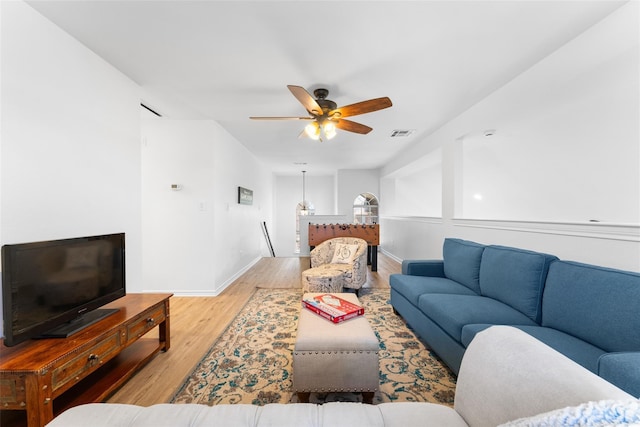 7022 Cottonwood Cir, Sachse, TX 75048 - living area with light wood-type flooring, visible vents, baseboards, and ceiling fan