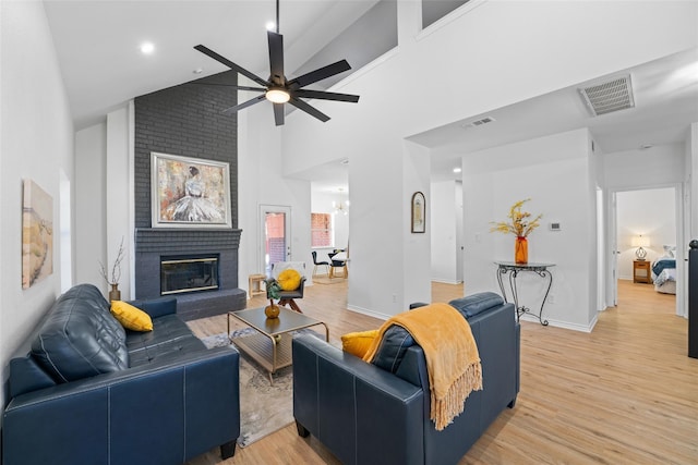 7022 Cottonwood Cir, Sachse, TX 75048 - living room featuring light wood-type flooring, a ceiling fan, visible vents, and high vaulted ceiling