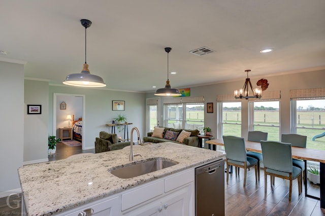 kitchen featuring open floor plan, dishwasher, a sink, and ornamental molding
