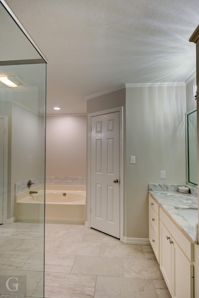 full bath with a garden tub, vanity, a textured ceiling, and crown molding
