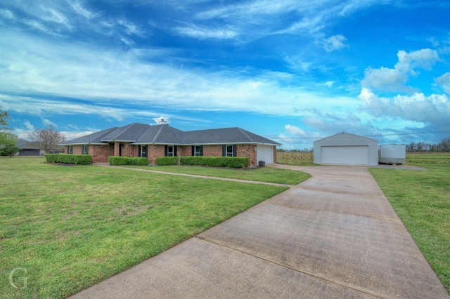 single story home with a front lawn, brick siding, and a detached garage