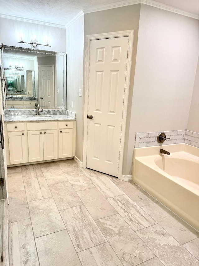 bathroom with baseboards, a garden tub, vanity, and crown molding
