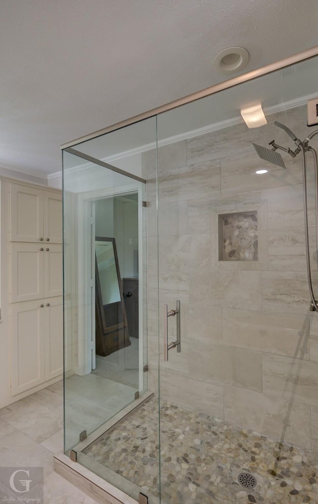 full bath with crown molding and a stall shower