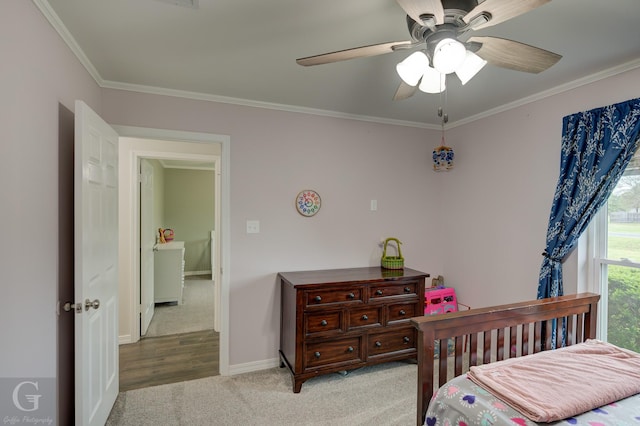bedroom with a ceiling fan, light carpet, ornamental molding, and baseboards