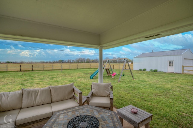 view of patio with a fenced backyard, outdoor lounge area, a rural view, and a playground