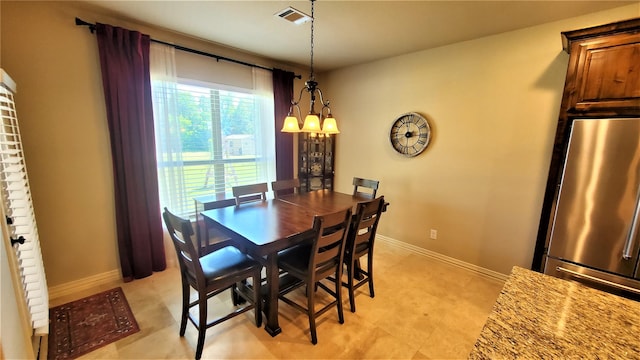 dining area with visible vents, baseboards, and an inviting chandelier