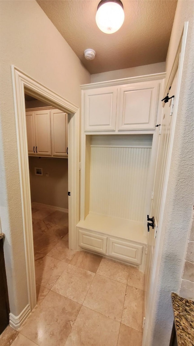 mudroom featuring a textured ceiling